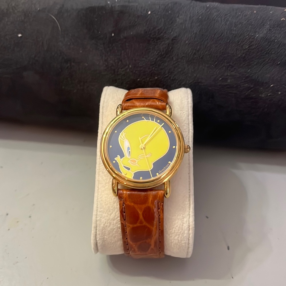 Tweety Bird watch. Gold tone with brown strap and hardware. Battery required.